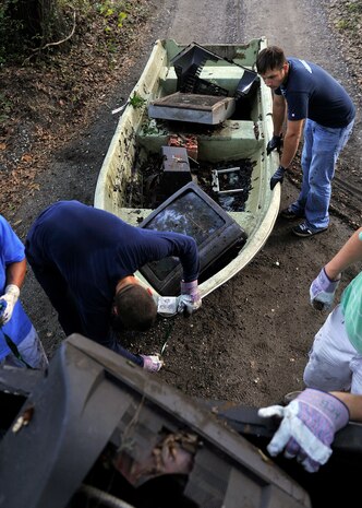 Chief Petty Officer Selectees Jon Everrett and Derek Mika, Naval Nuclear Power Training Command, collect debris from the Peas Hill Creek during a chief petty officer selectee community project Sept. 13, 2014, near James Island, S.C. Chief selectees participate in COMREL projects as part of the CPO 365 Phase 2 training. The project was coordinated with Keep Charleston Beautiful, an organization that encourages local groups to volunteer for clean-up projects across the state by providing trash bags, gloves and any necessary supplies they might need. The chief selectees pinned on their anchors Sept. 16. (U.S. Air Force photo/Staff Sgt. Renae Pittman)