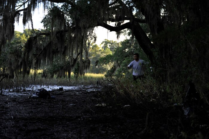 Chief Petty Officer Selectee Khalil Santos, Naval Nuclear Power Training Command, collects debris from the Peas Hill Creek during a chief petty officer selectee community project Sept. 13, 2014, near James Island, S.C. Chief selectees participate in COMREL projects as part of the CPO 365 Phase 2 training. The project was coordinated with Keep Charleston Beautiful, an organization that encourages local groups to volunteer for clean-up projects across the state by providing trash bags, gloves and any necessary supplies they might need. The chief selectees pinned on their anchors Sept. 16. (U.S. Air Force photo/Staff Sgt. Renae Pittman)