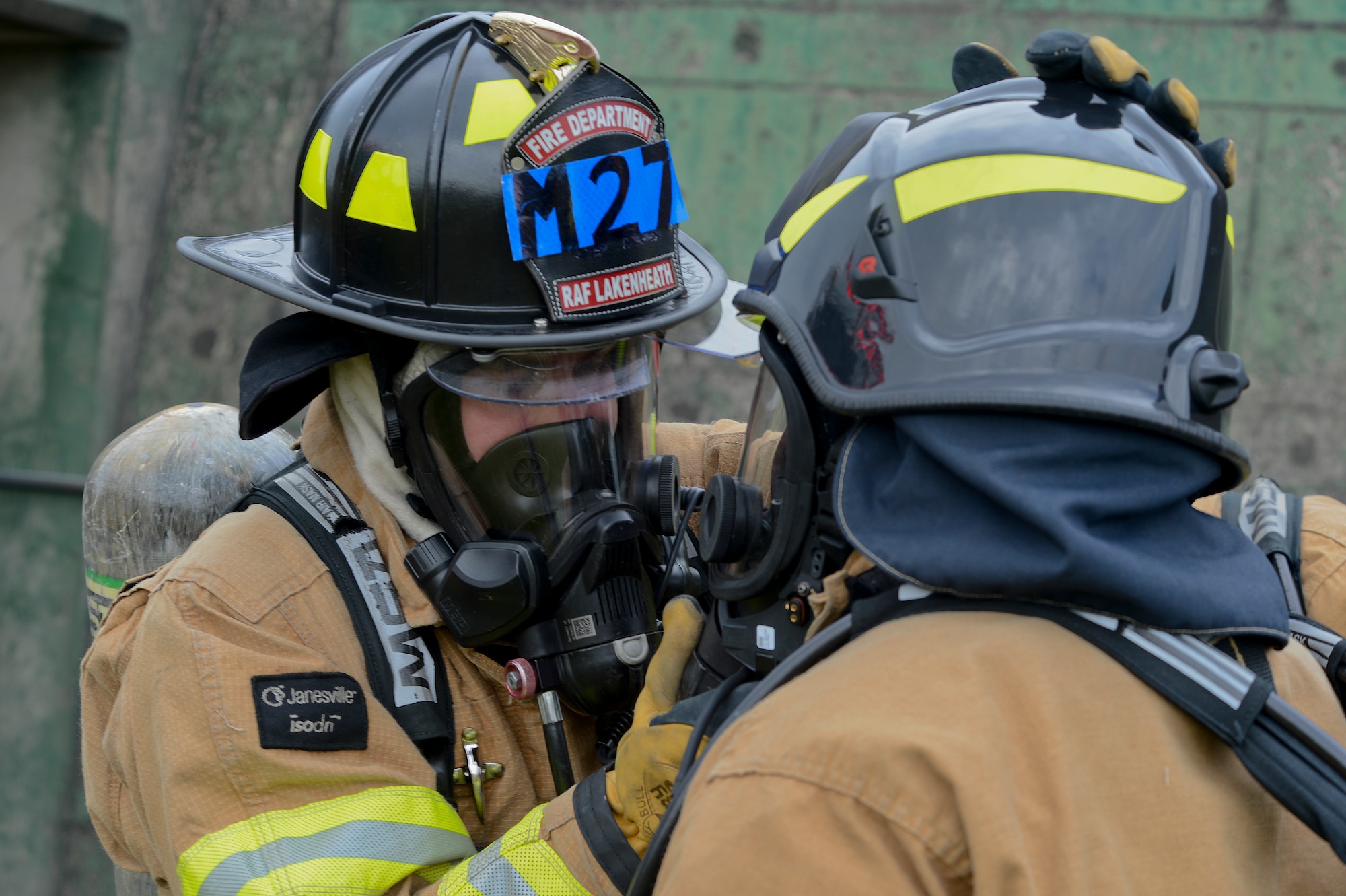 A 48th Civil Engineer Squadron firefighter secures equipment on his wingman during a base-wide mission assurance exercise at Royal Air Force Lakenheath, England, June 24, 2014. The three-day exercise was developed to test readiness and ensure Liberty Airmen adhere to proper procedures during emergencies or threatening conditions. (U.S. Air Force photo by Airman 1st Class Trevor T. McBride/Released)