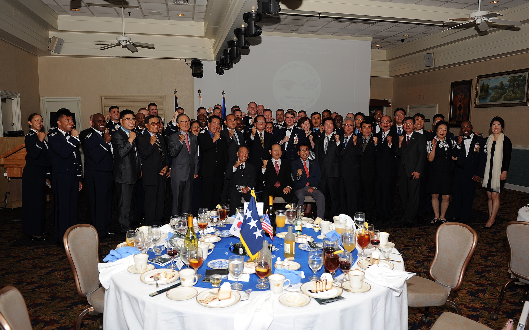 Members of Gunsan City and the Wolf Pack come together for a group photo during the 8th Fighter Wing 40th anniversary ceremony at Kunsan Air Base, Republic of Korea, Sept. 17, 2014.  Members of Gunsan City joined the Wolf Pack in celebrating 40 years of continuous friendship. (U.S. Air Force photo by Senior Airman Divine Cox)
