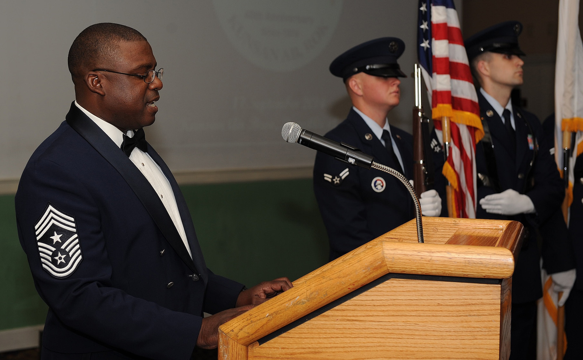 Chief Master Sgt. Lee “Wolf Chief” Barr, 8th Fighter Wing command chief, renders honors by singing the United States National Anthem at the 8 FW 40th anniversary ceremony Sept. 17, 2014, at Kunsan Air Base, Republic of Korea.  The Wolf Pack and members of Gunsan City celebrated 40 years of friendship with an evening of dinner and reminiscing fond memories. (U.S. Air Force photo by Senior Airman Divine Cox)