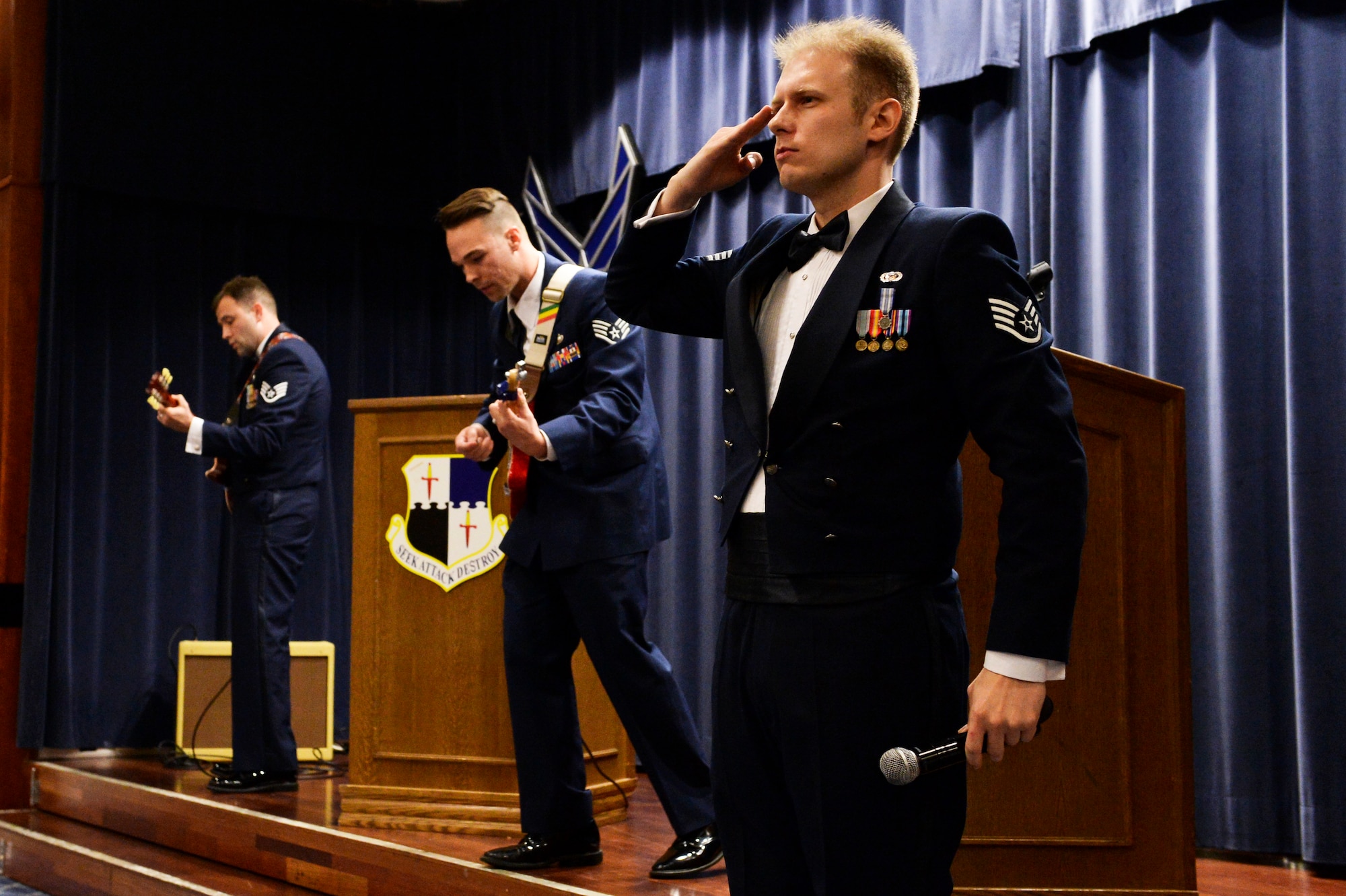 U.S. Air Force Staff Sgt. Joe W. McFadden, 52nd Fighter Wing Public Affairs, right, Staff Sgt. Kyle DeMarco, 52nd Medical Support Squadron, center, and Staff Sgt. Robbie Arp, 52nd FW Public Affairs, left, finish a song during the Air Force Ball at Club Eifel at Spangdahlem Air Base, Germany, Sept. 13, 2014. The Air Force Ball marked the 67th anniversary of the Air Force as its own military branch. (U.S. Air Force photo by Airman 1st Class Timothy Kim/Released)