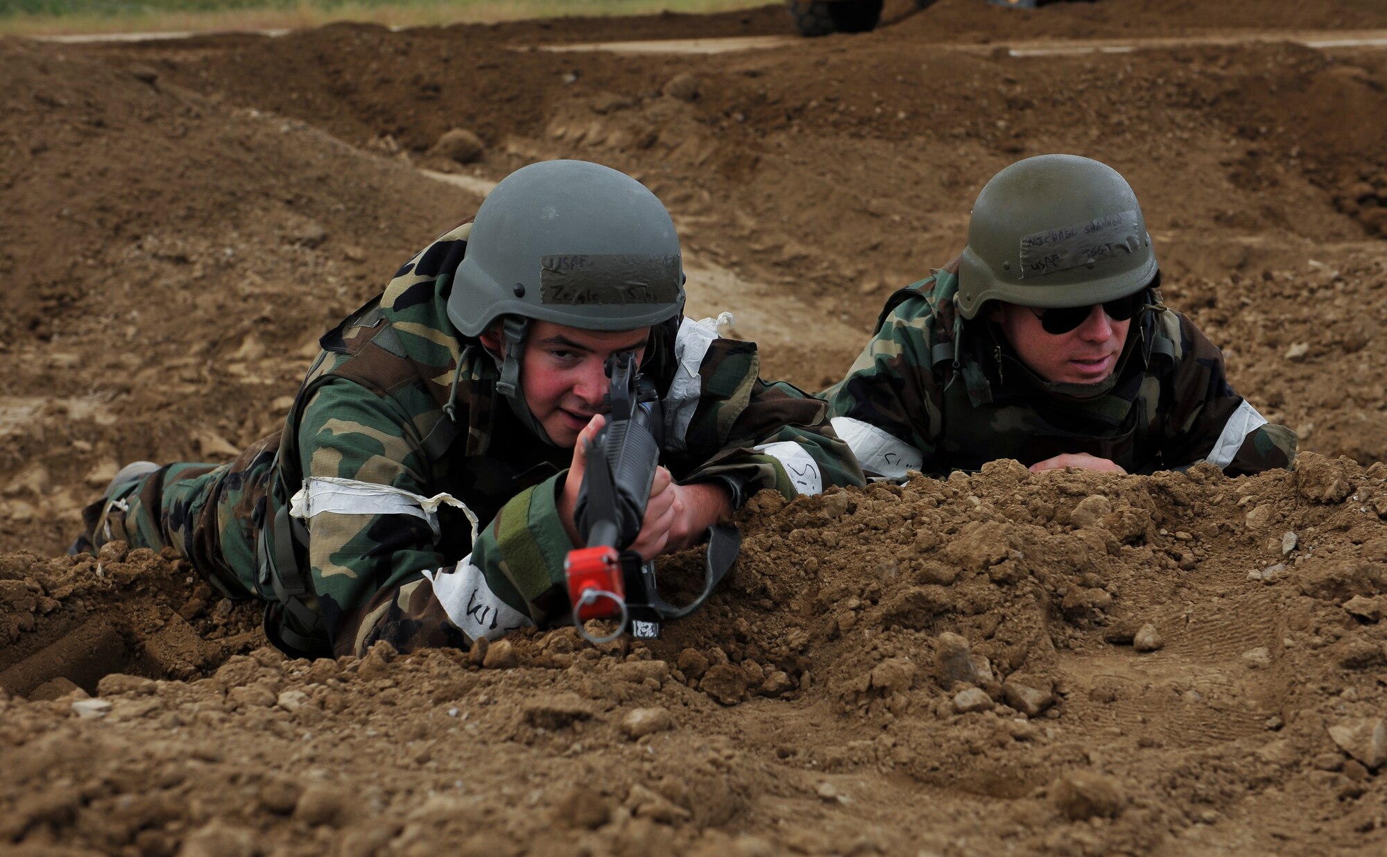 Senior Airman Samuel Ziegler, 51st Civil Engineer Squadron pavement and equipment journeyman, left, and Tech. Sgt. Michael Shannon, 51st CES pavement and equipment craftsman, watch for opposing force members during a simulated ground attack for operational readiness exercise Beverly Midnight 14-4 Sept. 18, 2014, at Osan Air Base, Republic of Korea. BM 14-4 is designed to test the joint operability of Team Osan and its partners. (U.S. Air Force photo by Senior Airman David Owsianka)
