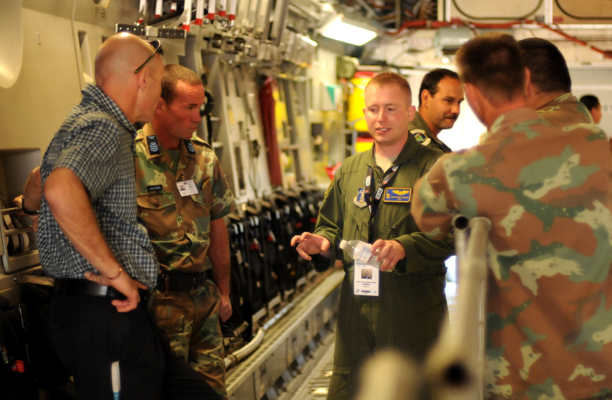 Staff Sgt. Christopher Cumming, a loadmaster from the New York Air National Guard's 137th Airlift Squadron, chats with South African air force members about his role on the C-17 Globemaster III during the opening day of the Africa Aerospace & Defence Expo 2014 Sept. 17, 2014, at Waterkloof Air Force Base, Pretoria, South Africa. U.S. Air Force Airmen and U.S. Army Soldiers attended the opening day of the 8th annual multinational event. United States military aircraft, including a C-130J Super Hercules and C-17 were on static display at the show, and the U.S. Army Golden Knights parachute demonstration team jumped into the opening ceremony alongside their South African counterparts, the Golden Eagles. (U.S. Air Force photo by Tech. Sgt. Austin M. May/Released)