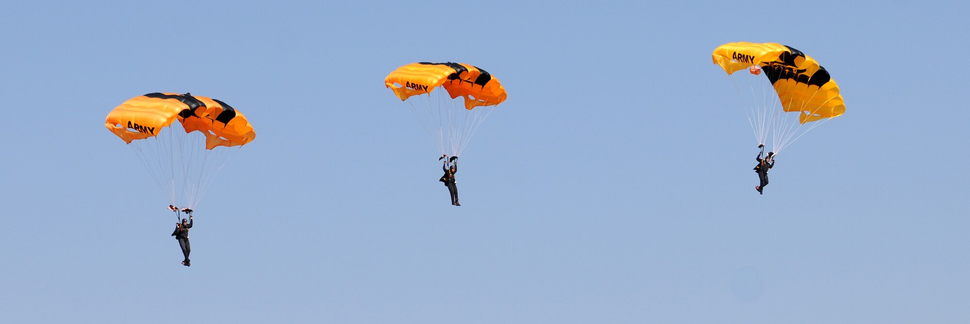 Soldiers from the U.S. Army Golden Knights parachute demonstration team jump into the opening ceremony of the Africa Aerospace & Defence Expo 2014 Sept. 17, 2014, at Waterkloof Air Force Base, Pretoria, South Africa. U.S. Air Force Airmen and U.S. Army Soldiers attended the opening day of the 8th annual multinational event. In addition to the Golden Knights, United States military aircraft, including a C-130J Super Hercules and C-17 Globemaster III were on static display at the show. (U.S. Air Force photo by Tech. Sgt. Austin M. May/Released)