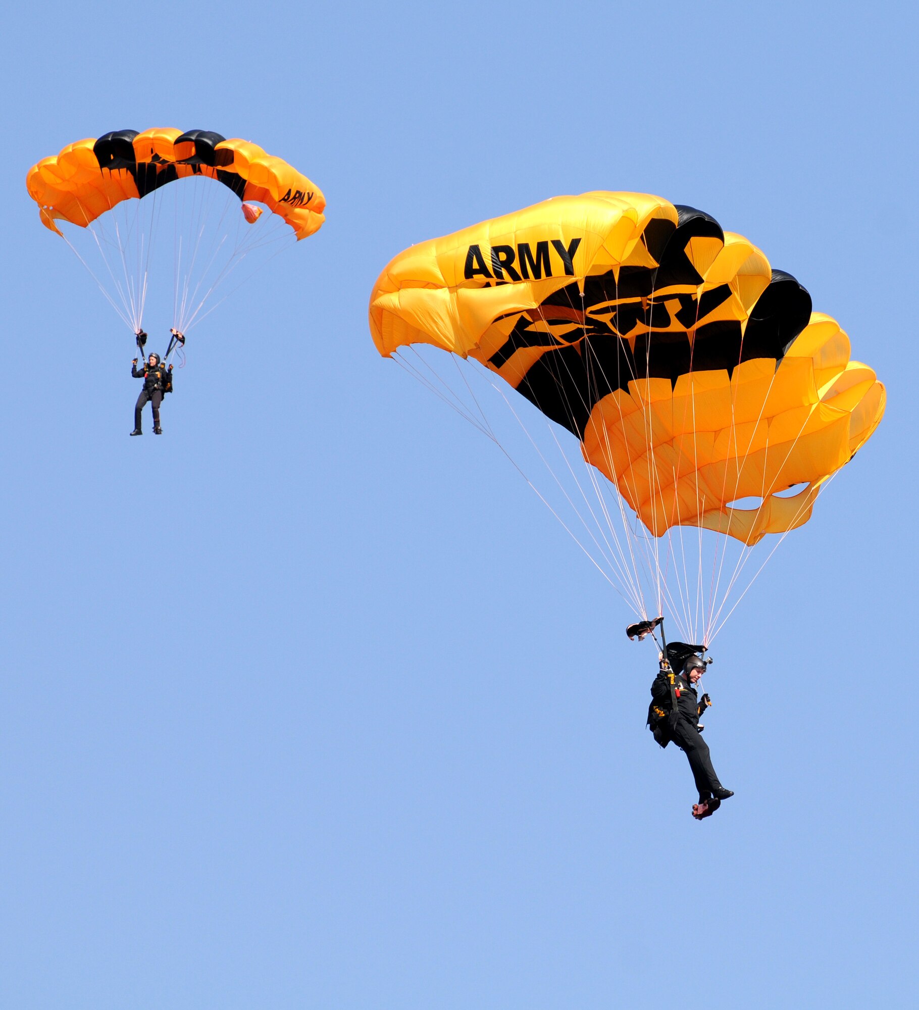 Soldiers from the U.S. Army Golden Knights parachute demonstration team jump into the opening ceremony of the Africa Aerospace & Defence Expo 2014 Sept. 17, 2014, at Waterkloof Air Force Base, Pretoria, South Africa. U.S. Air Force Airmen and U.S. Army Soldiers attended the opening day of the 8th annual multinational event. In addition to the Golden Knights, United States military aircraft, including a C-130J Super Hercules and C-17 Globemaster III were on static display at the show. (U.S. Air Force photo by Tech. Sgt. Austin M. May/Released)