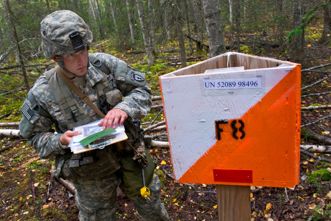 Army Spc. Mattew Ward arrives at a point on the land navigation course during Expert Infantryman Badge qualification on Joint Base Elmendorf-Richardson, Alaska, Sept. 9, 2014. Ward is assigned to the 25th Infantry Division's Company D, 3rd Battalion, 509th Infantry Regiment, 4th Infantry Brigade Combat Team. The division is based in Alaska.