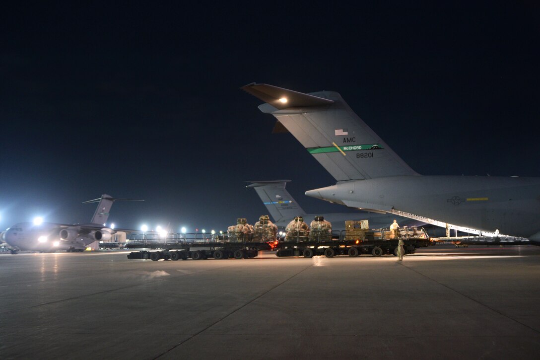 A U.S. Air Force C-17 Globemaster III aircraft sits next to a C-5 Galaxy as it is loaded with cargo on Bagram Airfield, Afghanistan, Sept. 9, 2014. Service members are conducting retrograde operations as the drawdown of forces in Afghanistan continues. 