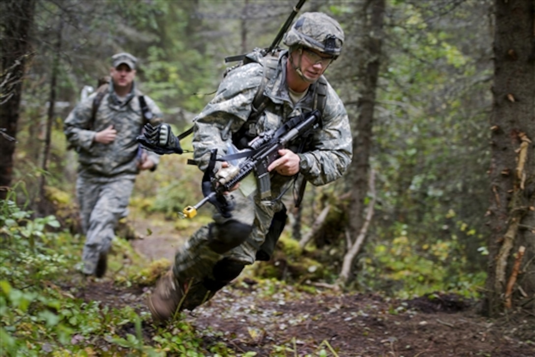 Army Sgt. Jonathan Gallogla rushes during Expert Infantryman Badge qualification on Joint Base Elmendorf-Richardson, Alaska, Sept. 10, 2014. Gallogla is assigned to the 25th Infantry Division's Company B, 1st Battalion, 501st Infantry Regiment, 4th Infantry Brigade Combat Team. The division is based in Alaska. The badge is awarded to Army personnel who hold infantry or special forces military occupational specialties and successfully pass the rigors of the course.