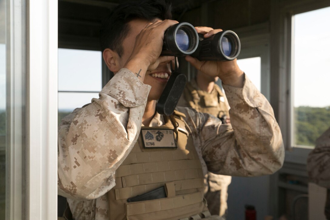 Sgt. Eduardo Castillo observes and impact area Aug. 31 at the Yausubetsu Maneuver Area during Artillery Relocation Training Program 14-2. During ARTP 14-2, fire support teams consisting of forward observers and field radio operators observed the impact area and directed fire missions for two separate artillery batteries. Castillo is a Los Angles, California, native and forward observer with 1st Battalion, 12th Marine Regiment, currently assigned to 3rd Battalion, 12th Marines, 3rd Marine Division, III Marine Expeditionary Force. 