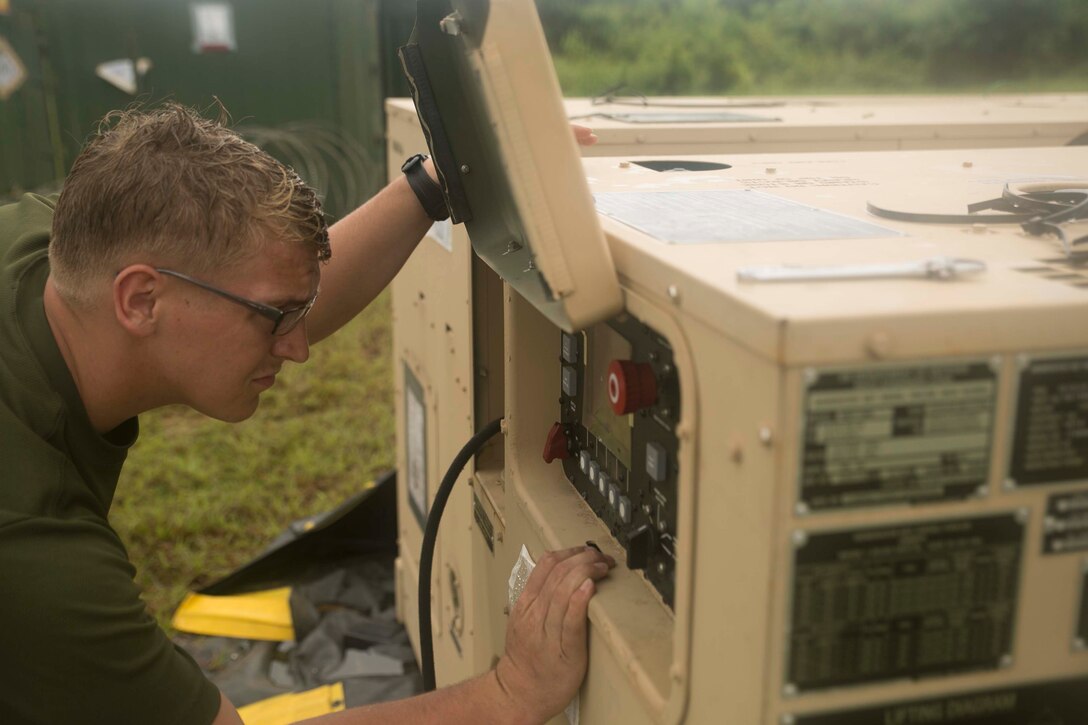 Cpl. Jeremiah D. Dorf, from Paynesville, Minn., a generator mechanic with Marine Air Control Squadron 4, Marine Air Control Group 18, 1st Marine Aircraft Wing, III Marine Expeditionary Force checks the generator connected to meteorological and oceanographic equipment in preparation of Valiant Shield 2014. Valiant Shield is a U.S.-only exercise integrating U.S. Navy, Air Force, Army and Marine Corps assets, offering real-world joint operational experience to develop capabilities that provide a full range of options to defend U.S. interests and those of its allies and partners. (U.S. Marine Corps photo by Lance Cpl. Tyler Ngiraswei/ Released)
