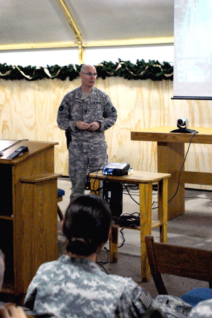 Army Capt. John Donovan addresses the soldiers attending a video teleconference at Contingency Operating Base Basra, Iraq, Dec. 17, 2009. In conjunction with the community of St. Cloud, Minn., the 34th Infantry Division hosted the teleconference to showcase the individuals and organizations the soldiers of central Minnesota will deal with when seeking veterans benefits.