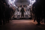 Redeploying Soldiers with the 1st Heavy Brigade Combat Team, 1st Cavalry Division, file onto a C-17 Globemaster III Jan. 26 at Camp Taji, Iraq. More than 8,000 Soldiers left Camp Taji and Baghdad International Airport in a 16-day period, marking the first fixed-wing redeployment operation from Iraq.