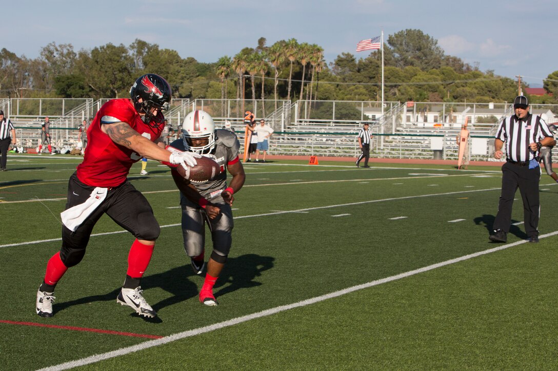 Ian Sumner, wide receiver with the Marine Corps Air Station Miramar Falcons, runs in for a touchdown during a game against the 11th Marines Cannon Cockers at Paige Fieldhouse aboard Marine Corps Base Camp Pendleton, Calif., Sept. 17. The Falcons defeated the Cannon Cockers 30-6. 