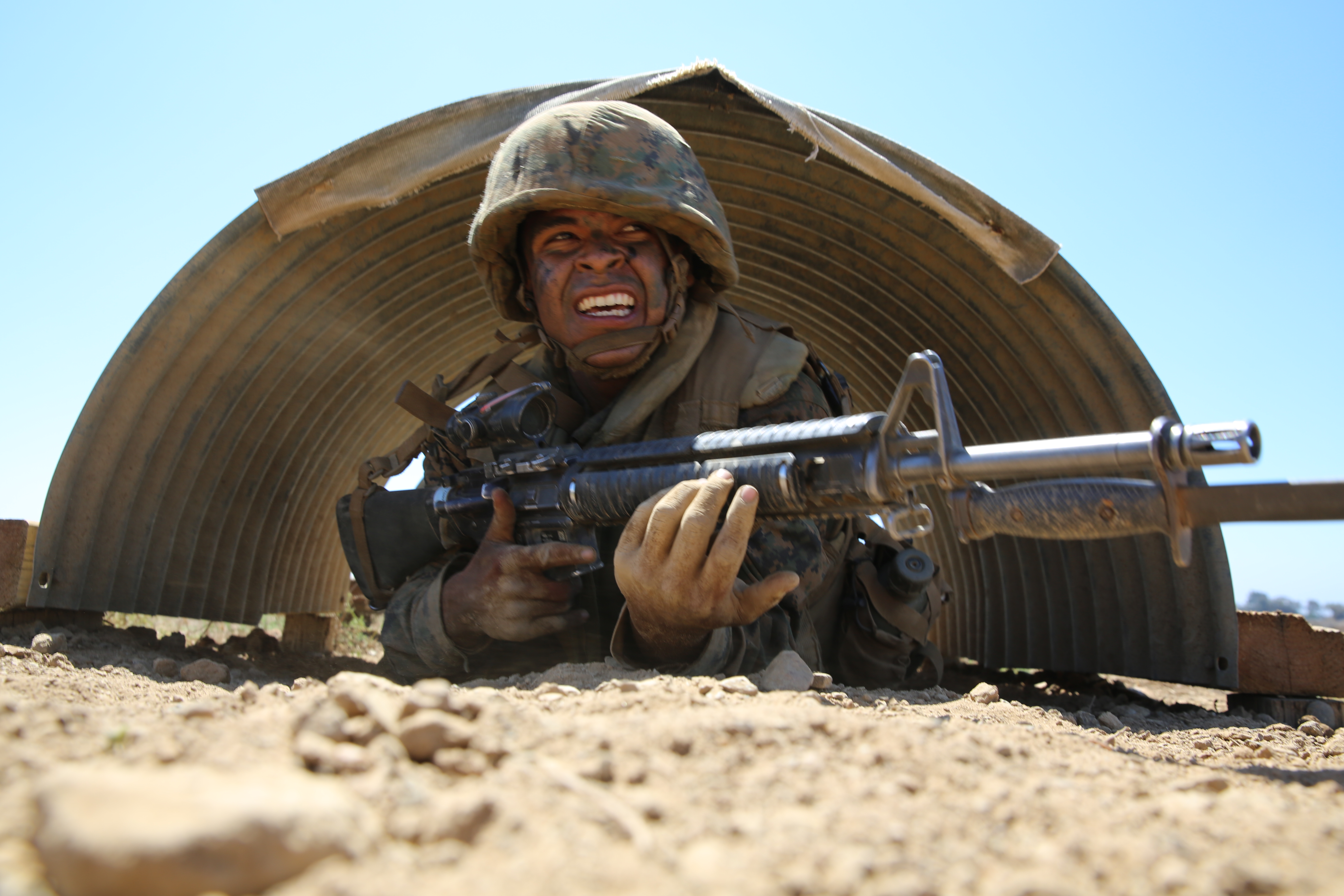 Private Alfonso A. Medina-Arellano, Platoon 3223, Kilo Company, 3rd Recruit Training Battalion, low crawls during the Bayonet Assault Course as part of the Crucible at Edson Range, Marine Corps Base Camp Pendleton, Calif. Sept 11. Over the past three months, recruits learned different bayonet techniques during Marine Corps Martial Arts Program training.