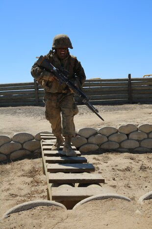 Private Alfonso A. Medinaarellano, Platoon 3223, Kilo Company, 3rd Recruit Training Battalion, runs across a bridge during the Bayonet Assault Course as part of the Crucible at Edson Range, Marine Corps Base Camp Pendleton, Calif. Sept 11. Over the past three months, recruits learned different bayonet techniques during Marine Corps Martial Arts Program training.