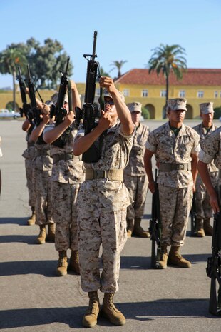 Recruits of Platoon 1041, Charlie Company, 1st Recruit Training Battalion, prepare their M-16 A4 service rifles for a drill movement during Final Drill at Marine Corps Recruit Depot San Diego, Calif., Sept. 15. Stack arms required recruits to neatly place their rifles, in stacks of five, without dropping a rifle.