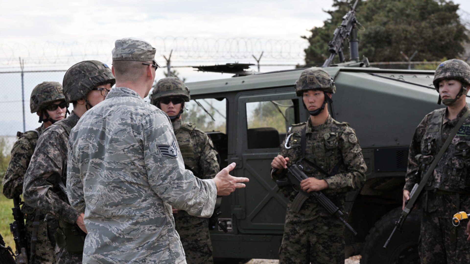 KUNSAN AIR BASE, Republic of Korea (Sept 16, 2014) - Staff Sgt. Calin Cronin, 8th Security Forces Squadron Air Base Defense non-commissioned officer in charge, provides feedback to Republic of Korea Air Force members following a simulated mounted and dismounted exercise during combat readiness training. Integrating Airmen of all ranks - from airmen basic to company grade officers - with ROKAF members in quarterly CRTs helps instill a mindset of teamwork to ultimately ensure maximum security and safety of the Wolf Pack family. 140916-F-ES731-338

