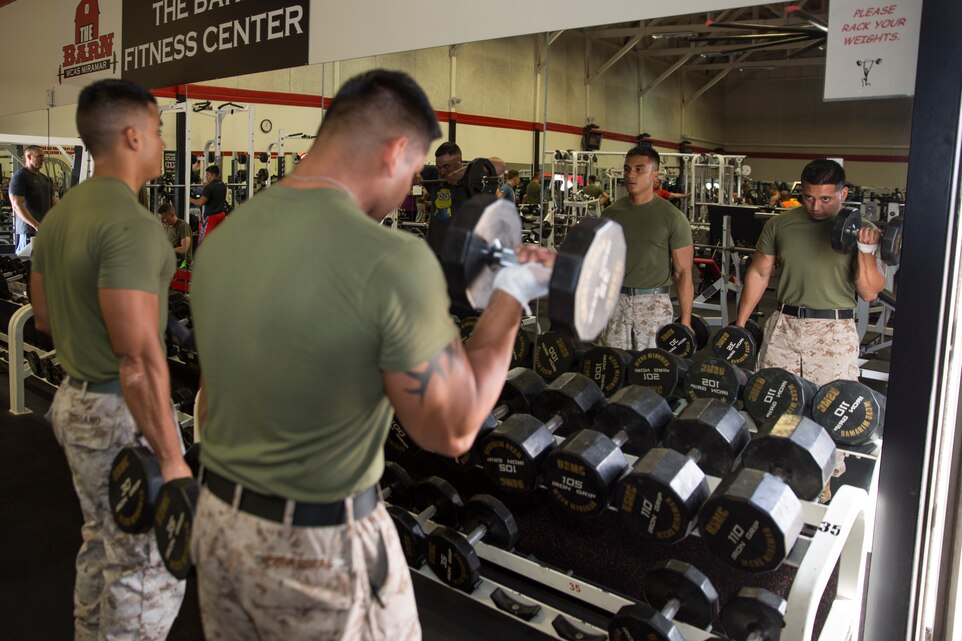 Cpl. Jonathan Soriano, Supply Repairable Control Branch noncommissioned officer in charge and Cpl. Roberto Contreras, a supply clerk, both with Marine Aviation Logistics Squadron (MALS) 11, perform bicep curls during an afternoon workout aboard Marine Corps Air Station Miramar, Calif., Sept. 19. Soriano shares his knowledge and passion freely with fellow Marines, whether leading physical training sessions or answering any questions they might have about their personal goals as Soriano learns more about fitness.