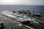 PACIFIC OCEAN (Sept. 17, 2014) - An F/A-18E Surper Hornet from the "Eagles" of Strike Fighter Squadron (VFA) 115 makes an arrested landing on the flight deck of the U.S. Navy's forward-deployed aircraft carrier USS George Washington (CVN 73) as part of Valiant Shiled. Valiant Shield is a U.S. only exercise integrating Navy, Air Force, Army, and Marine Corps assets, offering real-world joint operational experience to develop capabilities that provide a full range of options to defend U.S. interests and those of its allies and partners.  140917-N-IP531-347
