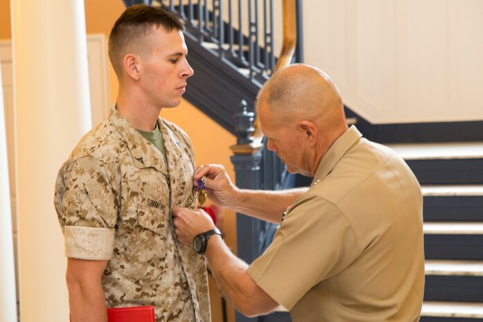 PORTSMOUTH, Va. (Sept. 19, 2014) – Lt. Gen. Robert B. Neller presented purple hearts to Lance Corporals William Simmons and Christopher Stidom in a ceremony at Portsmouth Naval Hospital Sept. 19, 2014. Both Marines are combat engineers and were with 2nd Combat Engineer Battalion stationed in Camp Lejeune. Simmons is a Lincoln, Neb. native and Stidom hails from Huntington, W. Va.