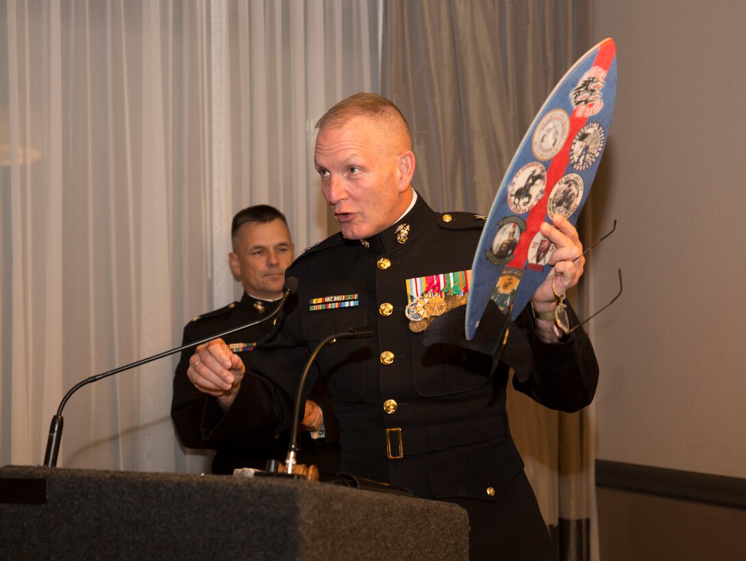 U.S. Marine Corps Maj. Gen. Mark A. Brilakis, commanding general, Marine Corps Recruiting Command, accepts a gift from the Marines of the 12th Marine Corps District while guest speaking at a Career Recruiter Conference Mess Night aboard MCAS Miramar, Sept. 18, 2014. The Mess Night is a borrowed tradition of ceremonial dining, and has become an honored tradition of enjoying drink, good food, and fellowship with a Marine's comrades, as well as honoring those who have perished in battle.  (U.S. Marine Corps photo by Cpl. Catie Massey/ Released)