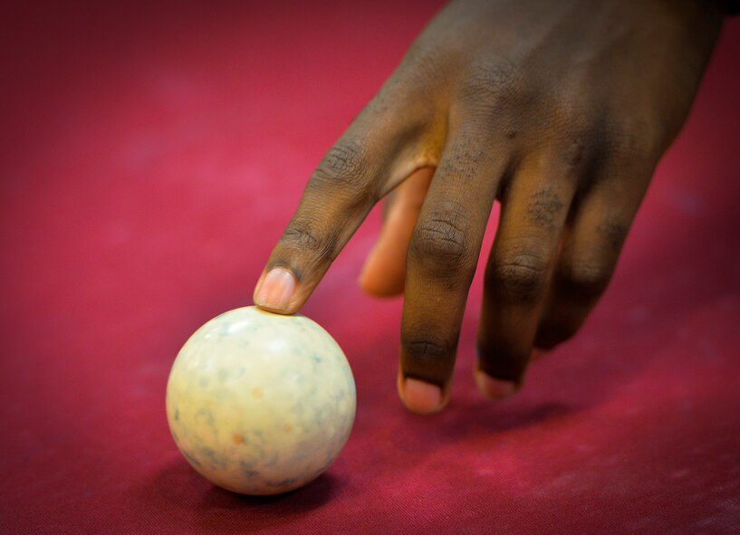 A cue ball is placed on a pool table during a pool tournament at the Landing Zone on Hurlburt Field, Fla., Sept. 11, 2014. The tournament was open to all Airmen and their families to provide a relaxing atmosphere a change from the fast pace Special Operations mission. (U.S. Air Force photo/Senior Airman Christopher Callaway) 