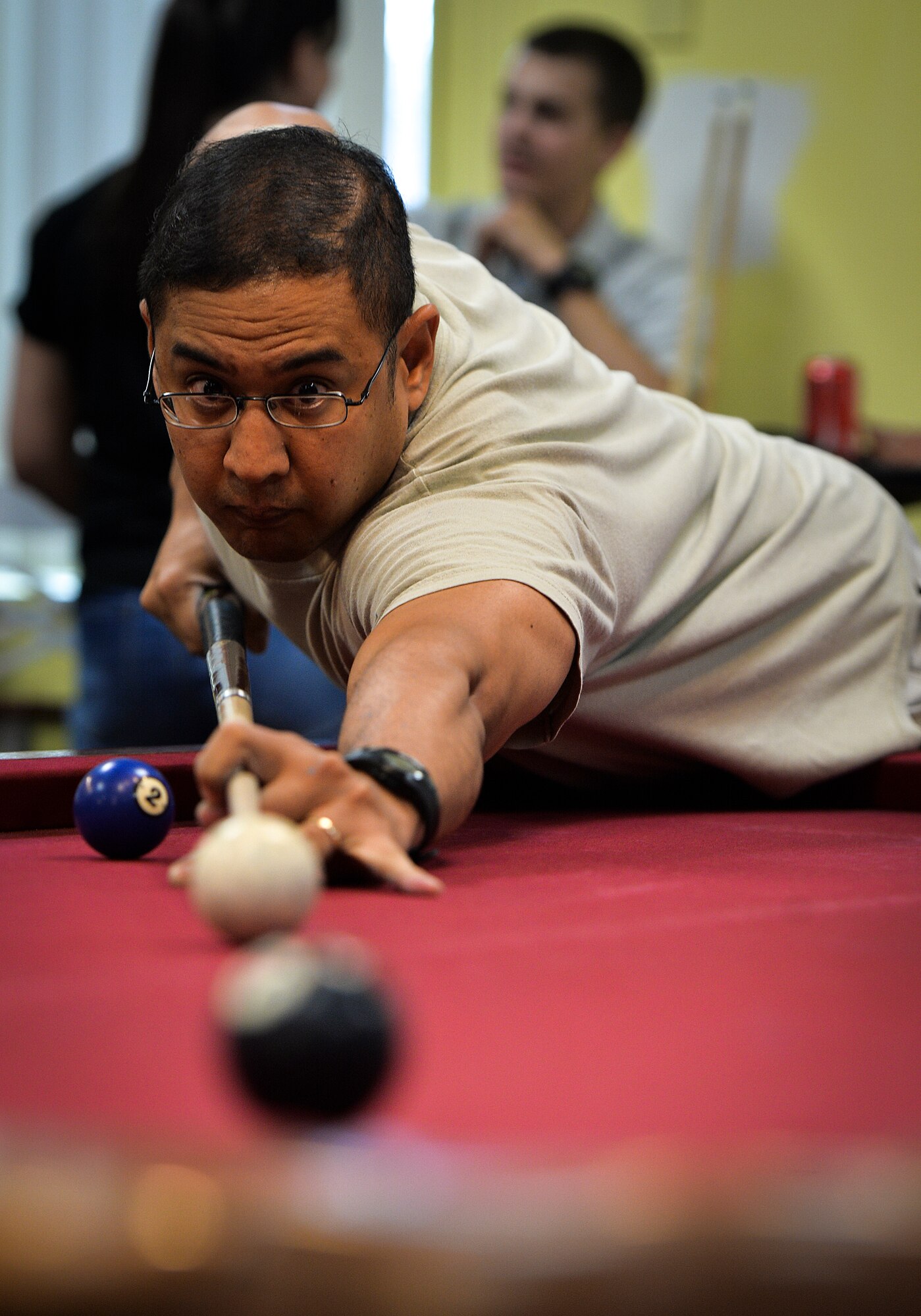 Maj. Robert Belardo, 15th Special Operations Squadron electronic warfare officer, lines up a game winning shot at the Landing Zone on Hurlburt Field, Fla., Sept. 11, 2014. Hurlburt Airman’s Voice hosted a pool tournament to help Airmen and their families relax from the fast pace Special Operations mission. (U.S. Air Force photo/Senior Airman Christopher Callaway) 