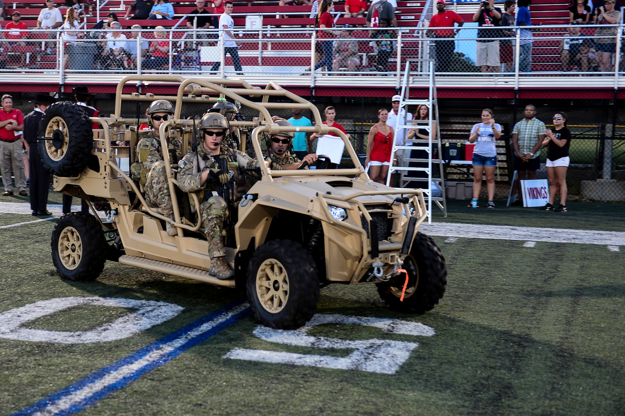 Members of the Special Tactics Training Squadron perform a capabilities demonstration at Fort Walton Beach High School, Fort Walton Beach, Fla., Sept. 12, 2014. FWB High School hosted the 24th Special Operations Wing for the school’s annual Military Appreciation Night. (U.S. Air Force photo/Airman 1st Class Jeff Parkinson)