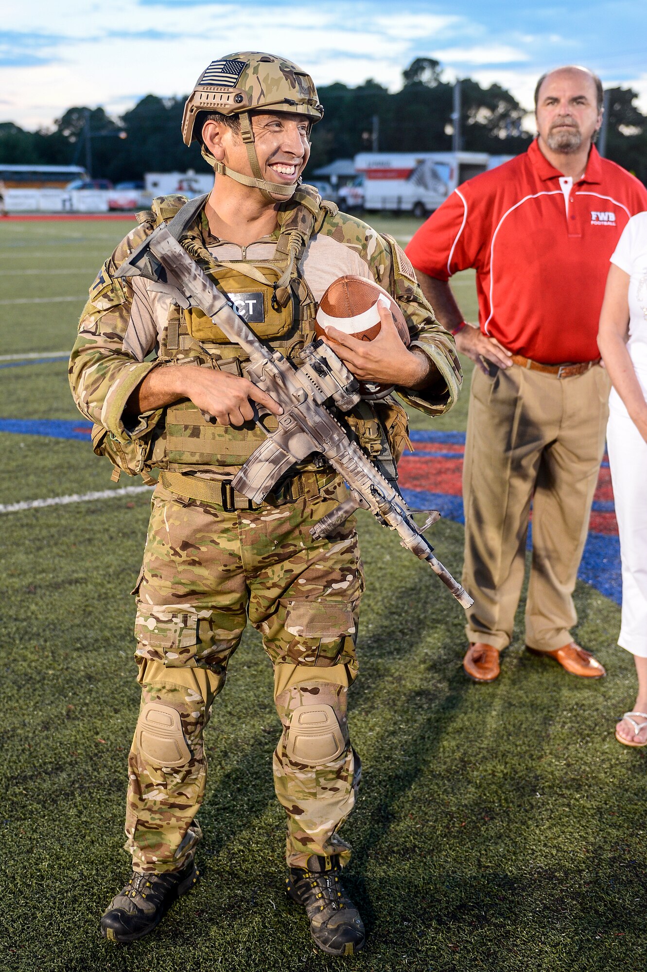 Tech. Sgt. Ismael Villegas, Special Tactics Training Squadron special tactics member, delivers the game football at Fort Walton Beach High School, Fort Walton Beach, Fla., Sept. 12, 2014. Fort Walton Beach High School hosted a military appreciation night, to pay tribute to the dedication of their local servicemen and women. . (U.S. Air Force photo/Airman 1st Class Jeff Parkinson)