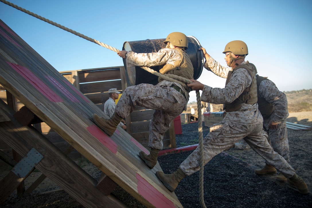 U.S. Marine Corps Career Recruiters, 12th Marine Corps District, engage in the Leadership Reaction Course (LRC)during the Career Recruiter Conference aboard Camp Pendleton, Calif., Sept. 18, 2014. The LRC establishes teamwork, problem solving skills, and builds camaraderie amongst the Marines. (U.S. Marine Corps photo by Cpl. Catie Massey/ Released)
