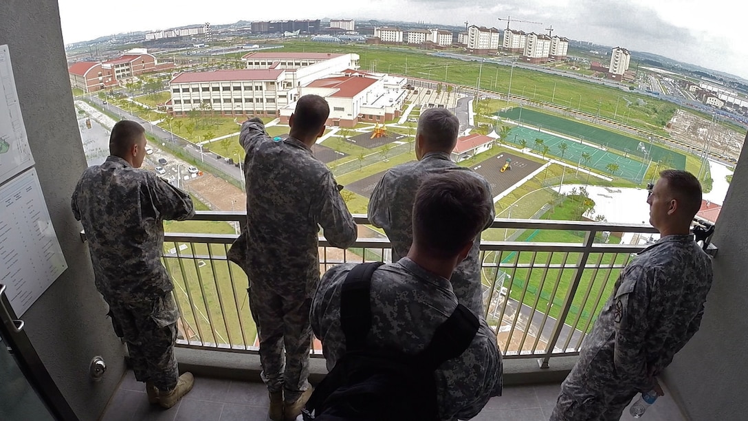 Col. Darin S. Conkright, commander of U.S. Army Garrison Humphreys and Area III, points out newly-opened school campuses and key construction projects to Lt. Gen. David D. Halverson, commander of the U.S. Army Installation Management Command and Assistant Chief of Staff for Installation Management, along with Command Sgt. Maj. Jeffrey S. Hartless, IMCOM command sergeant major (left) and Command Sgt. Maj. Matthew D. McCoy, U.S. Army Garrison Humphreys command sergeant major (right), July 25, 2014. U.S. Army Garrison Humphreys is currently home to one of the largest transformation, re-stationing and construction projects in Department of Defense history. 