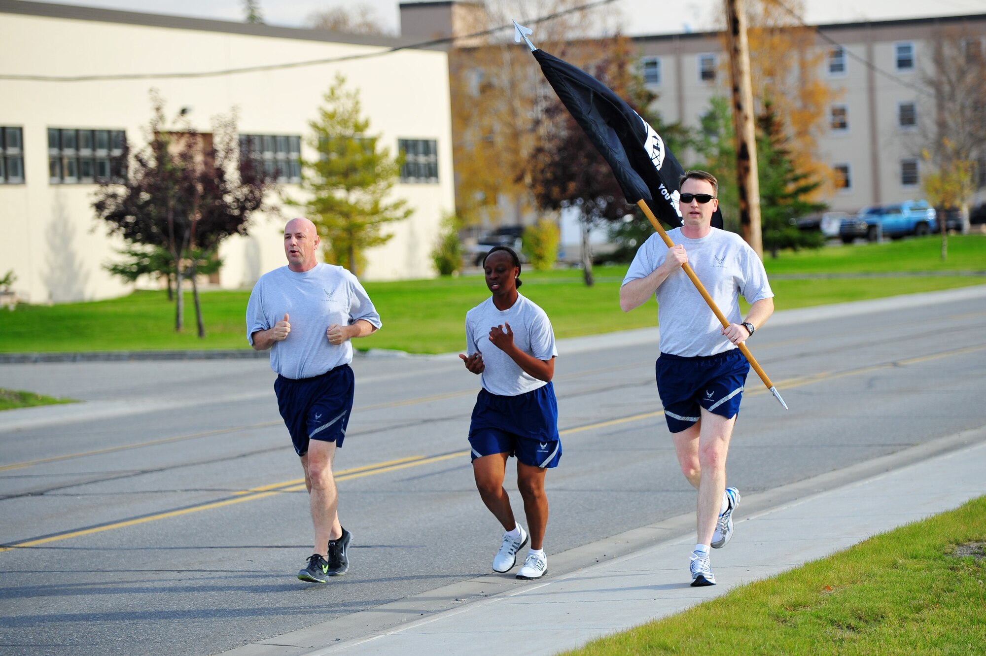 U.S. Air Force Chief Master Sgt. Michael Brown, 354th Fighter Wing command chief, Tech. Sgt. Jeannette Berry, 354th FW command chief executive assistant, and Maj. Justin Morrison, 354th Civil Engineer Squadron commander, run during a Prisoner of War/Missing in Action 24-hour vigil run Sept. 18, 2014, Eielson Air Force Base, Alaska. The POW/MIA run commemorates the men and women of the armed forces who gave immense sacrifices while in military service. (U.S. Air Force photo by Staff Sgt. Jim Araos /Released)