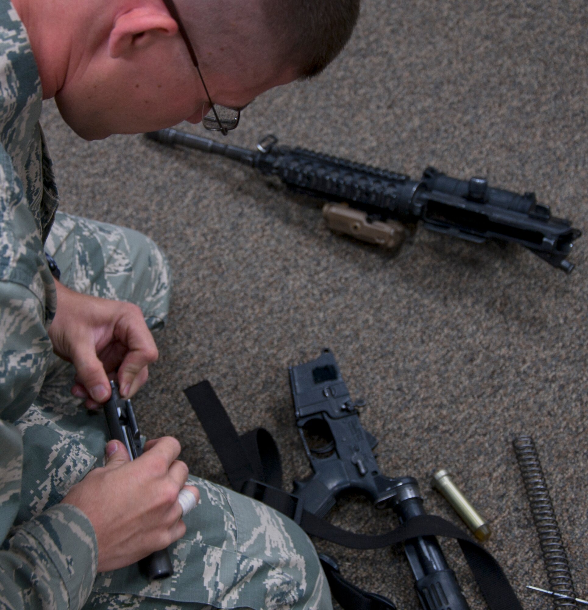 2nd Lt. Jeffery Davis, 90th Missile Security Forces Squadron, disassembles an M-4 rifle in Building 1250 Sept. 17. Davis and the rest of the 2014 90th Security Forces Group Global Strike Challenge team practiced this and other tasks in preparation for the GSC. (U.S. Air Force photo by Airman 1st Class Brandon Valle)