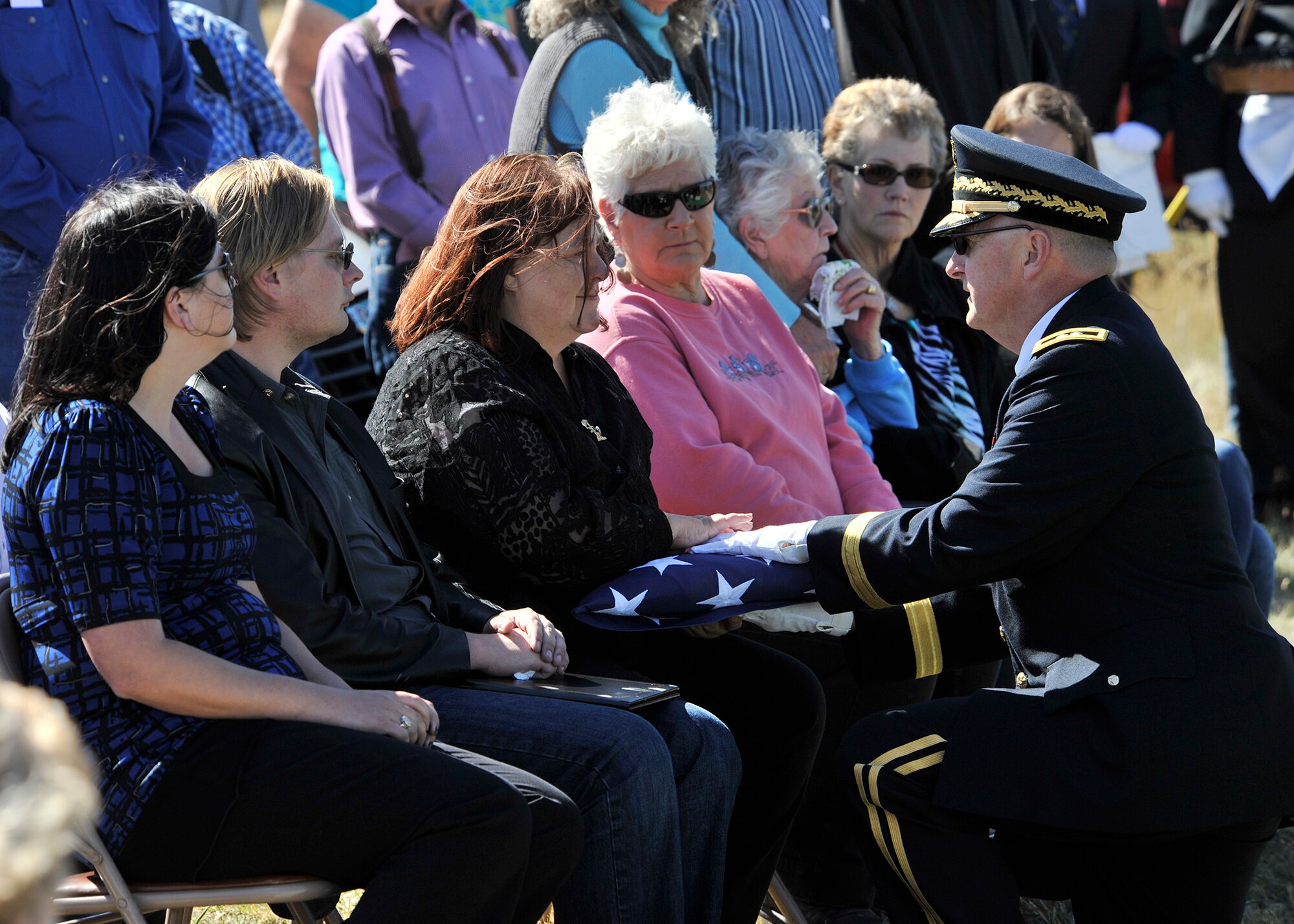 Maj. Gen. Matthew Quinn, Montana National Guard adjutant general, presents the folded flag from the casket of Army Air Forces 1st Lt. William D. Bernier to Sandi Jones, Bernier’s niece, Sept. 19 at Augusta Cemetery, Mont. Bernier was killed in action over New Guinea during WWII, and his remains were positively identified earlier this year. (Air Force photo/John Turner)
