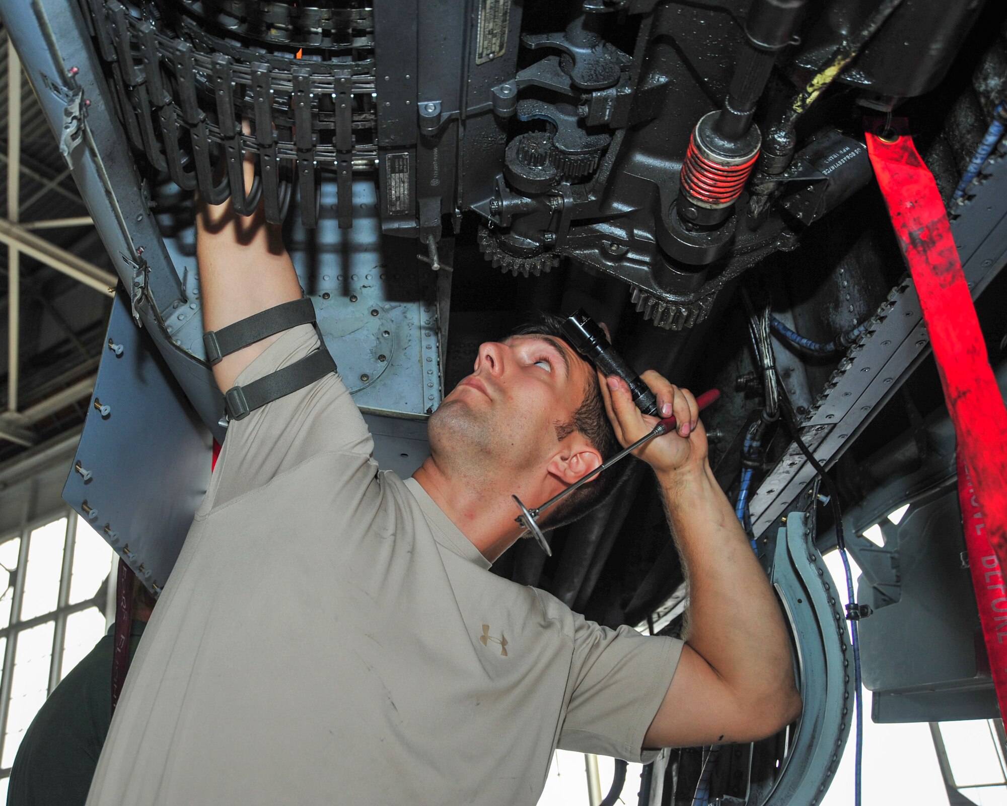 U.S. Air Force Staff Sgt. Mitchell Wiuff, 355th Equipment Maintenance Squadron armament systems technician, inspects a munitions feed on an A-10C Thunderbolt II at Davis-Monthan Air Force Base, Ariz., Sept. 16, 2014.  The 355th EMS maintains aerospace ground equipment, life support equipment, GAU-8 30-millimeter gun systems and aircraft weapons release systems.  (U.S. Air Force Photo by Airman 1st Class Chris Massey/Released)