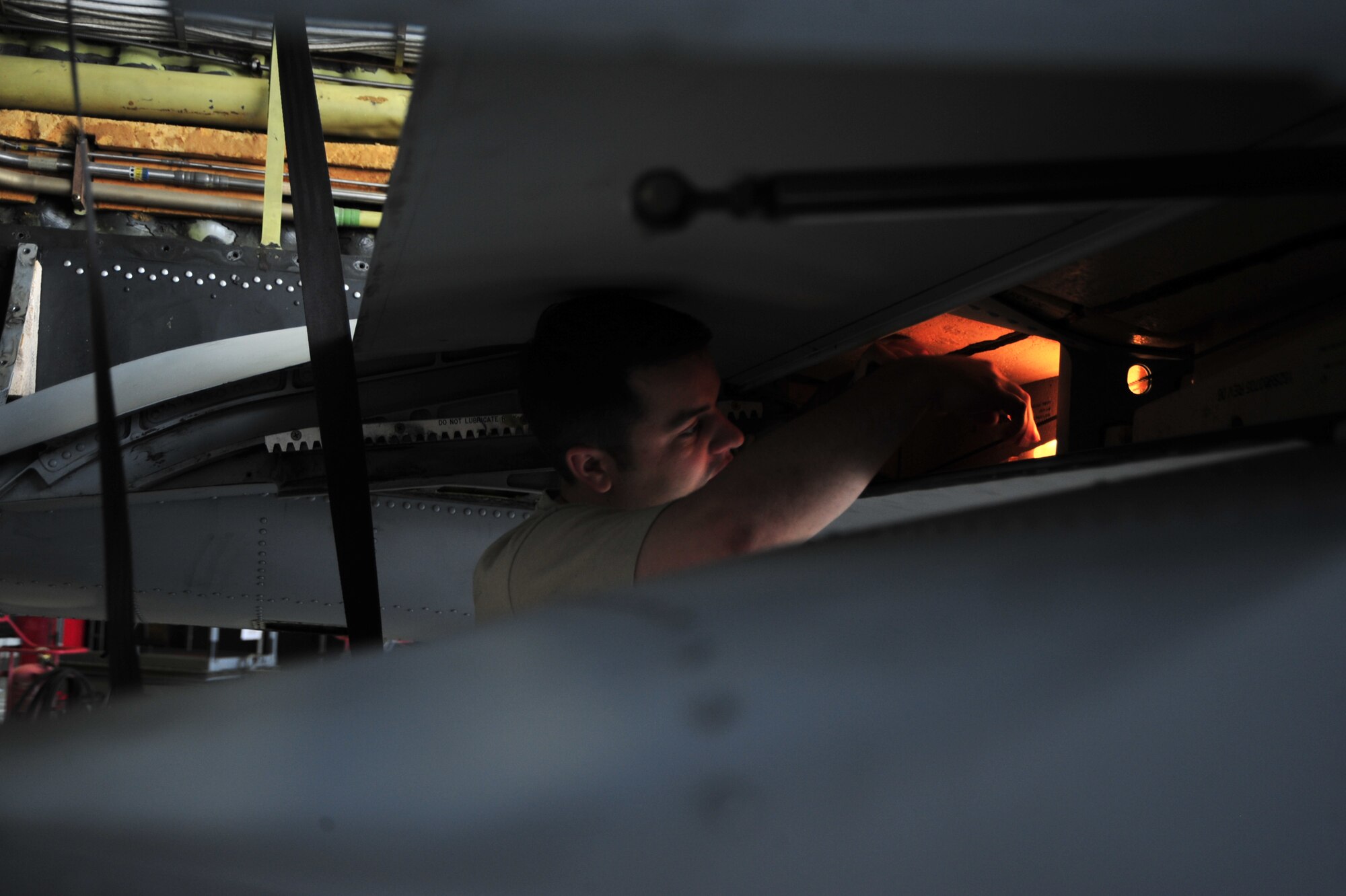 U.S. Air Force Staff Sgt. Matthew Rykhus and Staff Sgt. Michael Engel, 355th Equipment Maintenance Squadron crew chiefs, perform a phase inspection on an A-10C Thunderbolt II at Davis-Monthan Air Force Base, Ariz., Sept. 16, 2014.  A-10s are sent to the phase hangar every 500 hours for in-depth inspections.  (U.S. Air Force Photo by Airman 1st Class Chris Massey)