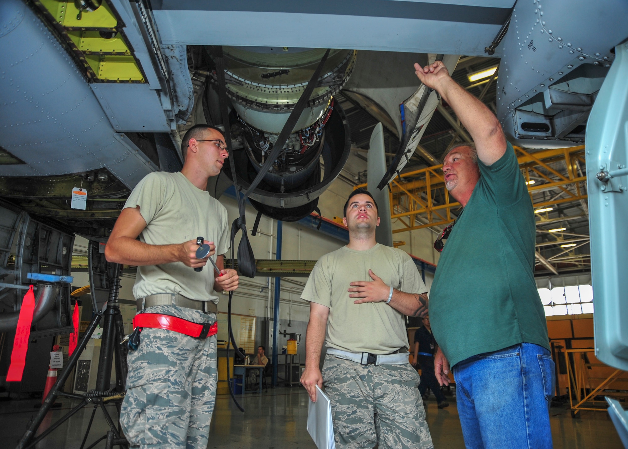U.S. Air Force Staff Sgt. Michael Engel, Staff Sgt. Matthew Rykhus and Dean Queen, 355th Equipment Maintenance Squadron crew chiefs, perform a phase inspection on an A-10C Thunderbolt II at Davis-Monthan Air Force Base, Ariz., Sept. 16, 2014. Throughout the inspection, 355th EMS maintainers give the A-10 a complete in-depth inspection, looking for foreign object debris, damage, cracked or worn parts and also ensure that every section of the airframe is intact with each piece in its proper place.  (U.S. Air Force Photo by Airman 1st Class Chris Massey/Released)