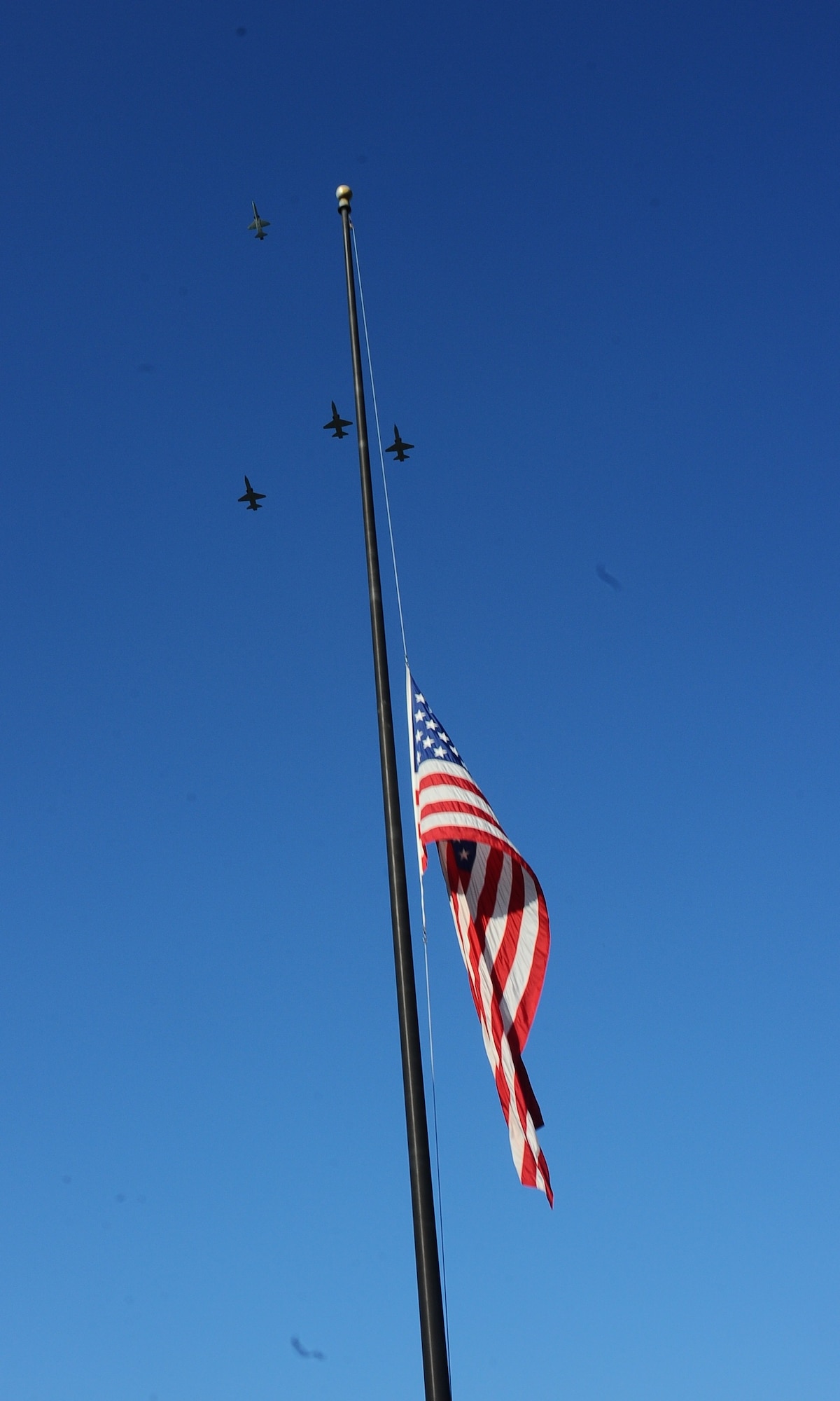 A Missing Man formation flies over Columbus Air Force Base during a memorial service Sept. 19 at Smith Plaza. The service was dedicated to remembering Maj. Richard Schafer, 49th Fighter Trainer Squadron. The missing man formation is an aerial salute performed as part of a flyover of aircraft at a funeral or memorial event, typically in memory of a fallen pilot.  (U.S. Air Force photo/Airman John Day)