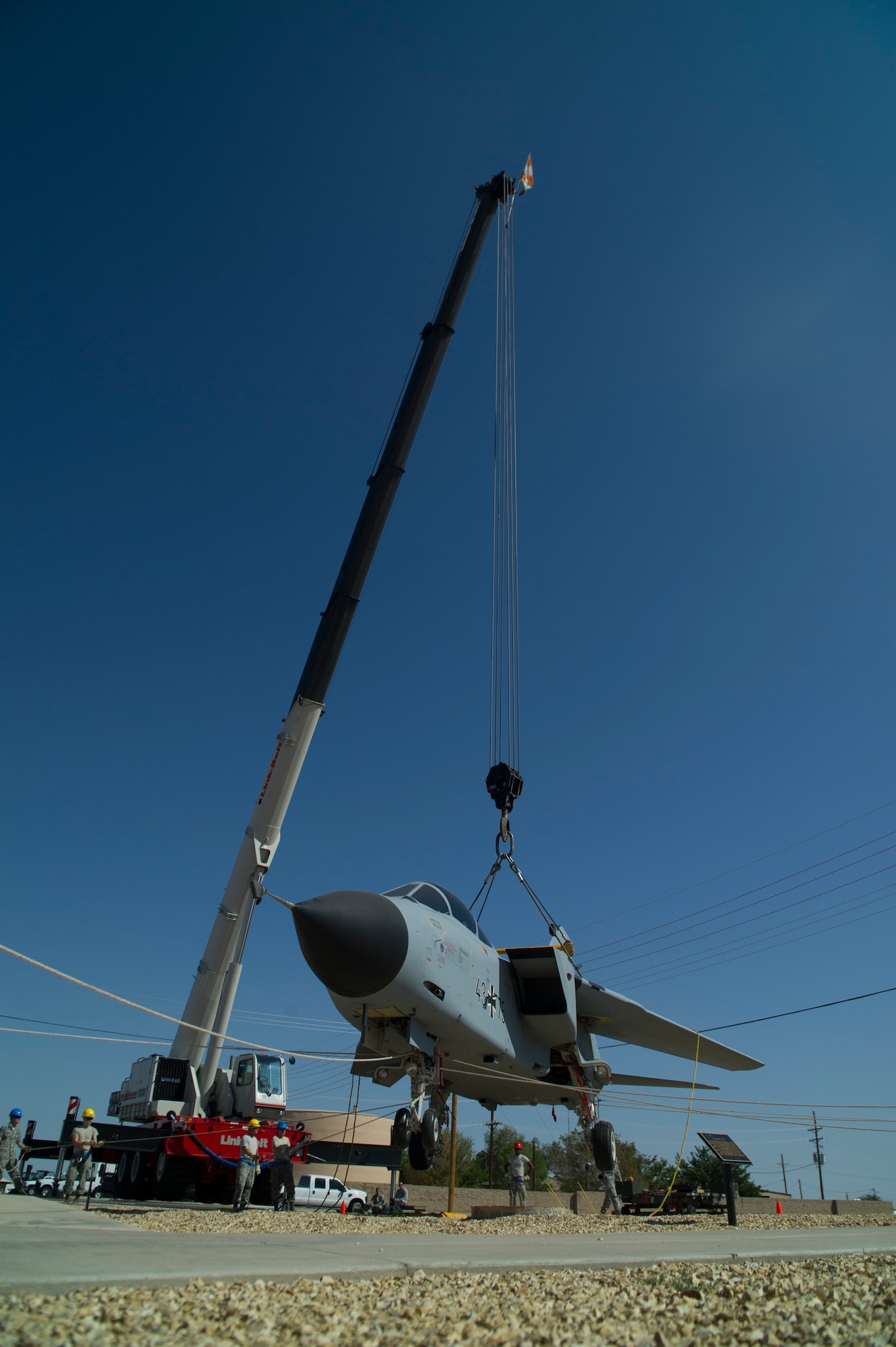 Members of the 49th Maintenance Group crash recovery team hoist a German Air Force Tornado onto it’s final resting place at Heritage Park among other historical aircraft that have been flown at Holloman Air Force Base, N.M., July 19. History was made Sep. 19, when a German Air Force static aircraft was unveiled in Heritage Park by Lt. Gen. Martin Schellis, GAF Flying Training Center commander, and Col. Robert Kiebler, 49th Wing commander. The GAF Training Center and the Tornados are a significant part of military aviation operations in and around Holloman Air Force Base and the White Sands Missile Range. (U.S. photo by Airman 1st Class Aaron Montoya / Released)