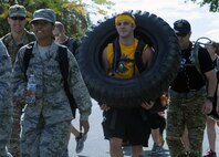 Members of Team Fairchild begin the Prisoner of War and Missing in Action 5K ruck march at Fairchild Air Force Base, Wash., September 19, 2014. The event was used as an opportunity to remember and pay tribute to POW/MIA personnel. Remembering those who have come before is a long-lasting tradition in the military. (U.S. Air Force photo by Staff Sgt. Samantha Krolikowski/Released)
