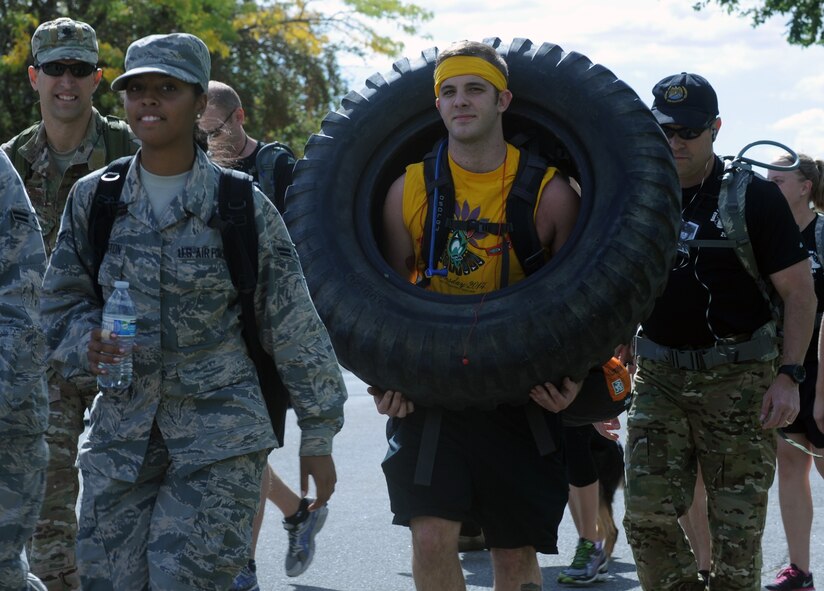 Members of Team Fairchild begin the Prisoner of War and Missing in Action 5K ruck march at Fairchild Air Force Base, Washington, September 19, 2014. The event was used as an opportunity to remember and pay tribute to POW/MIA personnel. Remembering those who have come before is a long-lasting tradition in the military. (U.S. Air Force photo/Staff Sgt. Samantha Krolikowski)