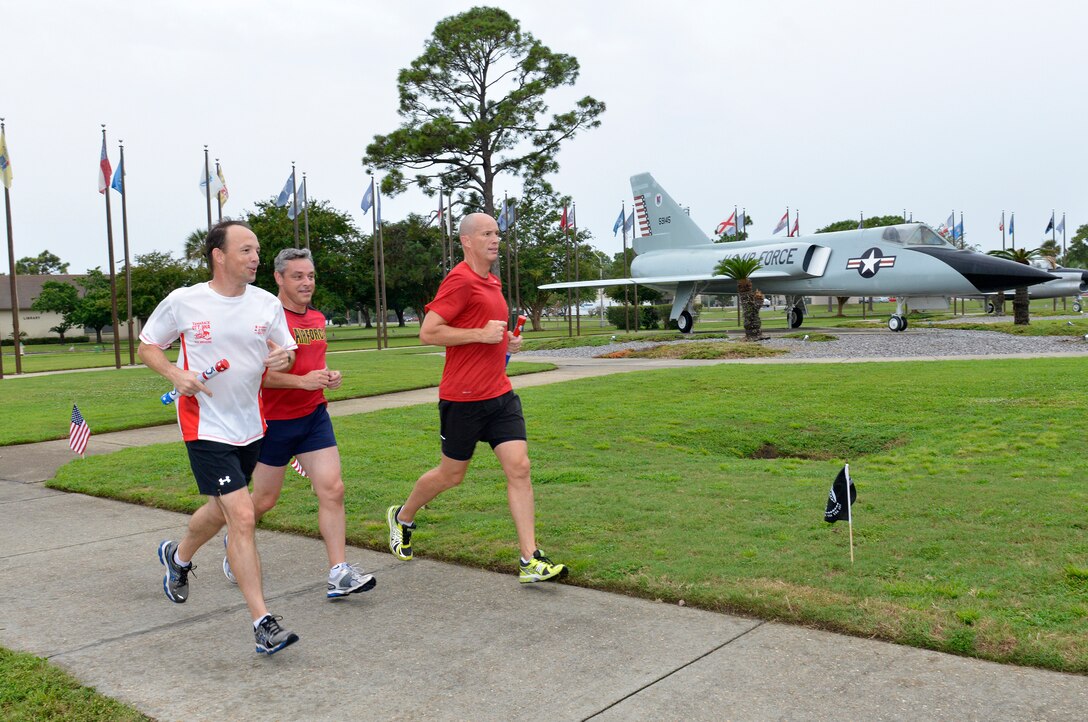 9/19/2014 – TYNDALL AIR FORCE BASE, Fla. – Canadian Royal Air Force members run in the Prisoner of War/Missing in Action 24-hour Vigil Run Sept. 18-19. BGen Alain Pelletier, Continental United States NORAD Region deputy commander, Maj Bruno Baker, executive officer, and LCol Scott Greenough, Canadian Detachment commander, participate in the 25-year tradition started by the 81st Range Control Squadron. More than 200 runners from 24 units around the installation ran in the relay event at Flag Park. National POW/MIA Recognition Day is traditionally observed on the third Friday in September each year. (U.S. Photo by Master Sgt. Kurt Skoglund/Released)