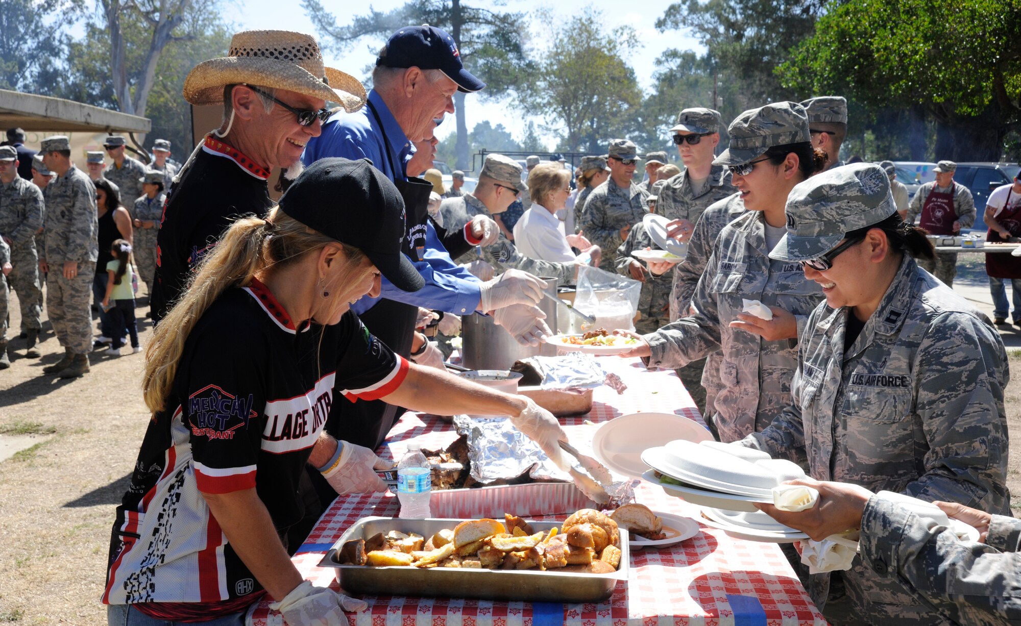 Airmen receive food as the line progresses at a military appreciation barbeque, Sept. 19, 2014, Vandenberg Air Force Base, Calif. The barbeque, sponsored by the Lompoc Valley Chamber of Commerce, has been held annually for several years. (U.S. Air Force photo by Airman Robert J. Volio/Released)