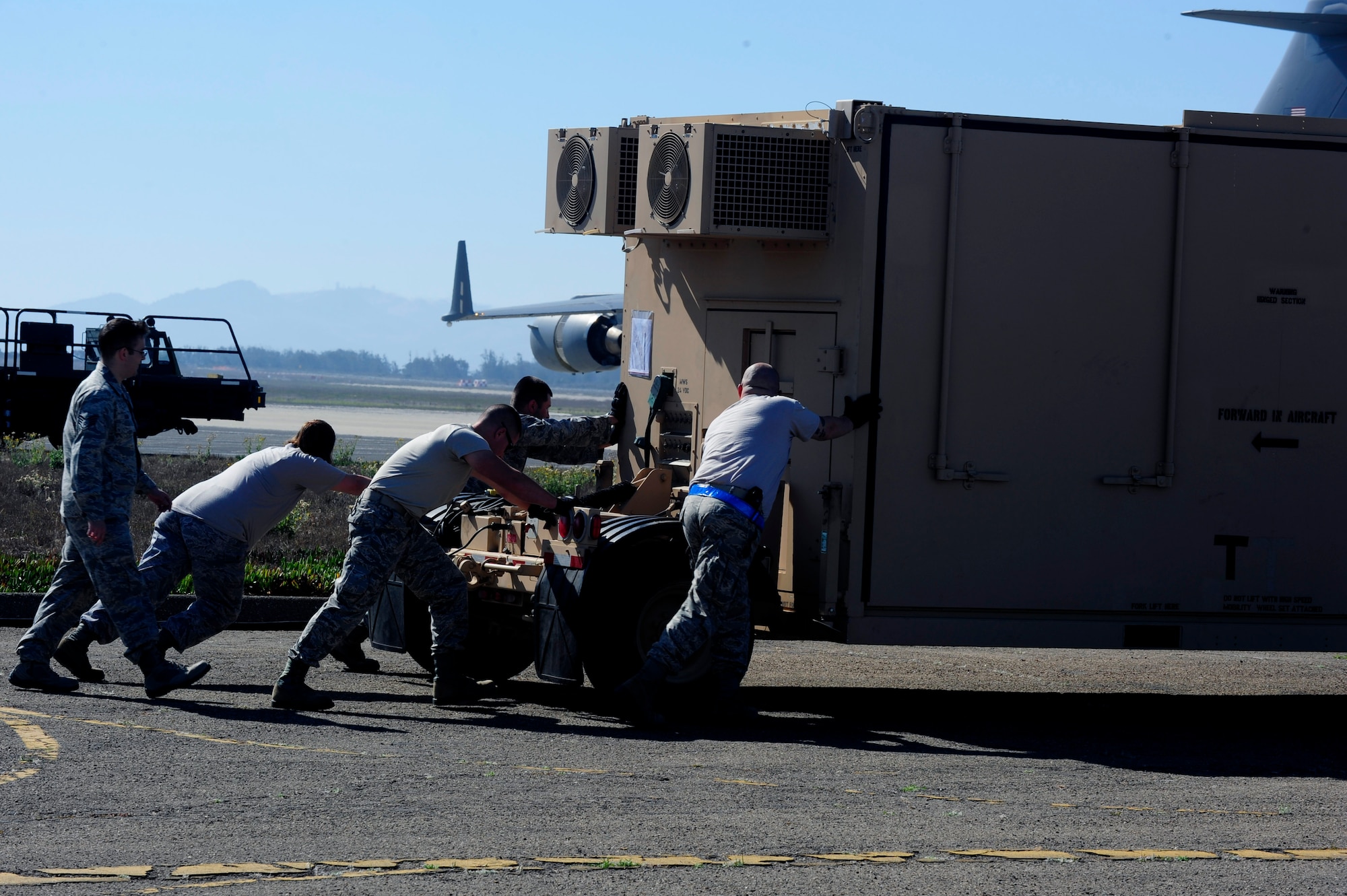 Airmen from the 570th Contingency Response Group set up equipment during an Air Combat Operations Training Exercise, Sept. 15, 2013, Vandenberg Air Force Base, Calif. The 20-person team, of Airmen from various career fields, aimed to effectively practice standing up an operational airfield in a deployed environment -- where resources may be scarce. (U.S. Air Force photo by Senior Airman Shane Phipps/Released)