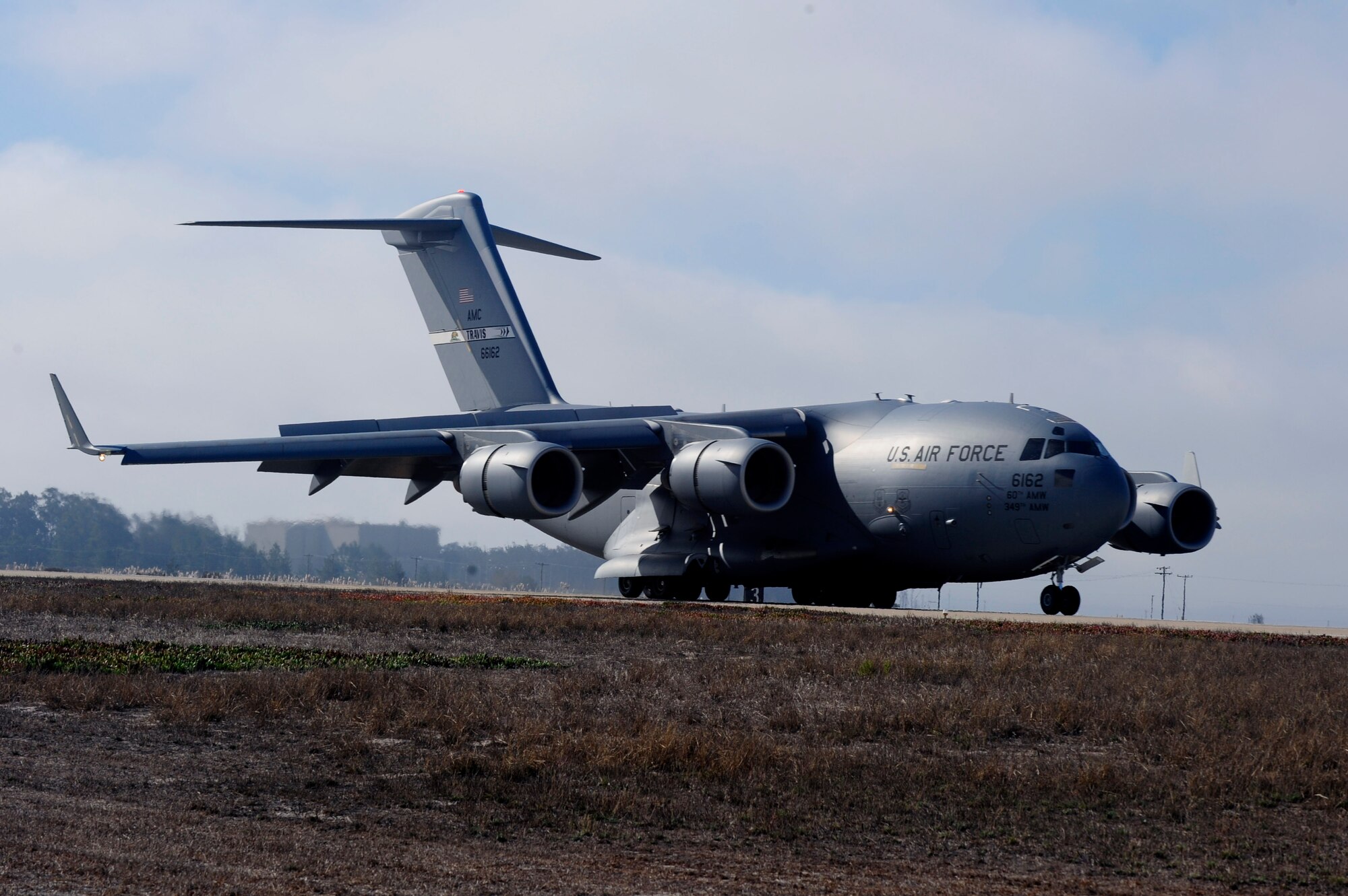A C-17 Globemaster III from the 60th Air Mobility Wing taxis the runway, Sept. 15, 2014, Vandenberg Air Force Base, Calif. The aircraft made the trip from Travis Air Force Base, California, for an Air Combat Operations Training Exercise, held by Airmen with the 570th Contingency Response Group, Sept. 15 through 17. (U.S. Air Force photo by Senior Airman Shane Phipps/Released)