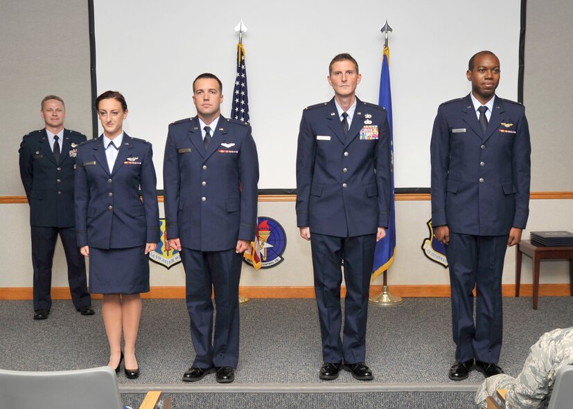 Four Team Tyndall graduates stand at attention during their Air Battle Manager Class 14017 graduation ceremony Sept. 17. (U.S. Air Force photo by Airman 1st Class Ty-Rico Lea)