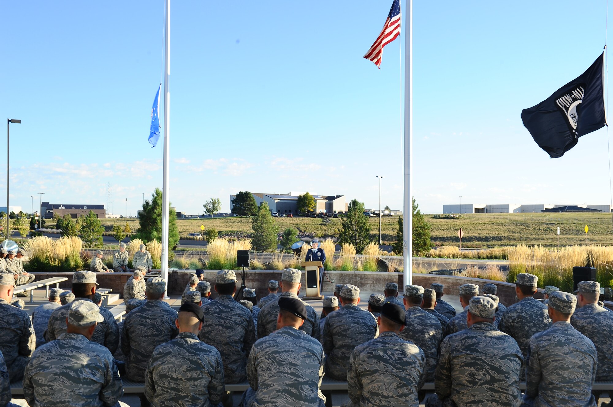 Team Buckley members listen to Col. Mitch Stratton, 460th Space Wing vice commander, during the POW/MIA reveille ceremony Sept. 19, 2014, at the 460th Space Wing headquarters building on Buckley Air Force Base, Colo. According to the Defense Prisoner of War/Missing Personnel Office, more than 83,000 Americans are missing from World War II, the Korean War, the Cold War, the Vietnam War and the 1991 Gulf War. (U.S. Air Force photo by Tech. Sgt. Rob Hazelett/Released)