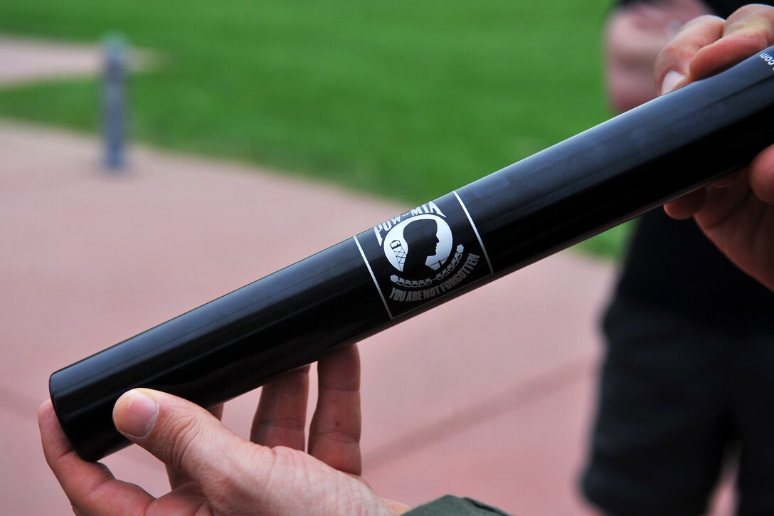 U.S. Air Force Col. Mark Williamson, 55th Wing vice commander, holds a special baton before the start of the Prisoner of War/Missing in Action Memorial 24-Hour Run held on the parade ground Sept. 19-20, Offutt Air Force Base, Nebraska. The inaugural event was organized by the Air Force Sergeant’s Association and included volunteers from across the installation running individually and as part of teams for 24 hours straight. (U.S. Air Force Photo by Charles Haymond)