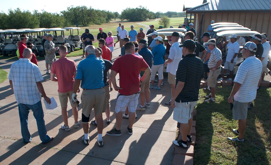 U.S. Air Force Master Sgt. Michael Clutz, 7th Operations Support Squadron, explains the rules and regulations to participants of the Salute to Your Service golf tournament Sept. 5, 2014, at Dyess Air Force Base, Texas. The golf tournament proceeds benefitted local wounded combat veteran, Michael Burns, and his family. (U.S. Air Force photo by Airman 1st Class Alexander Guerrero/Released)